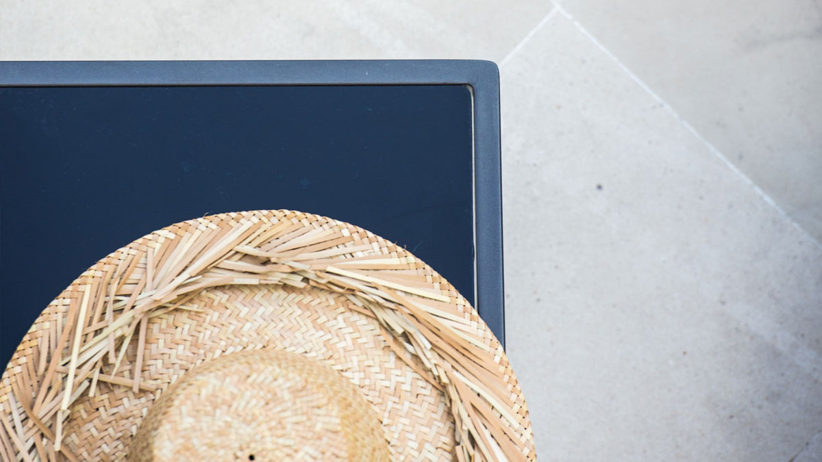 top view of a side table with a straw hat on it