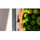 a bowl of limes on a wooden table