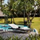 a pool with lounge chairs