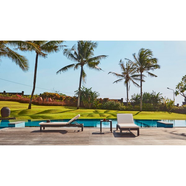 a wooden deck with lounge chairs and a pool