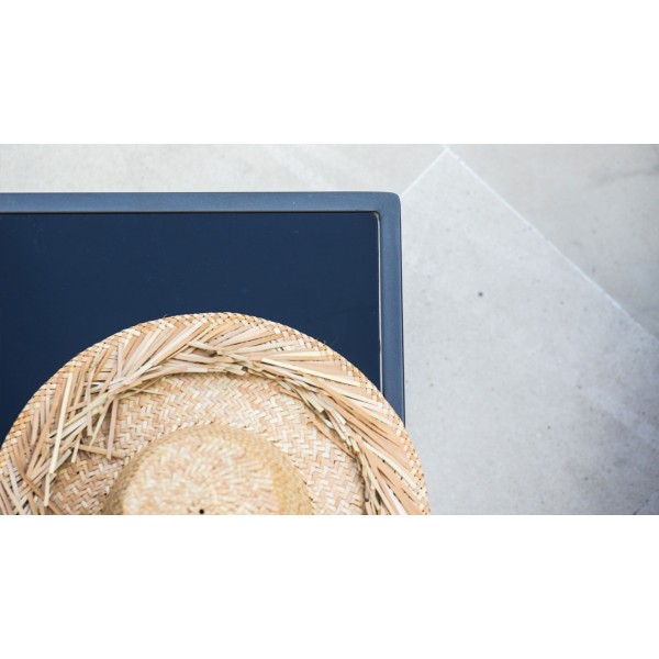 top view of a side table with a straw hat on it
