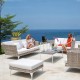 two women sitting on a patio with a view of the ocean