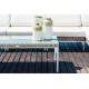 a white couch and vases on a wooden deck