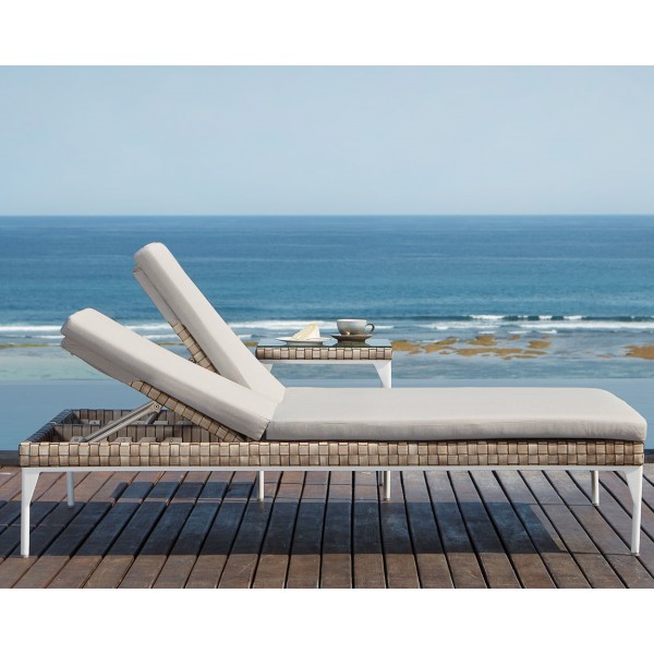 a lounge chair on a deck overlooking the ocean