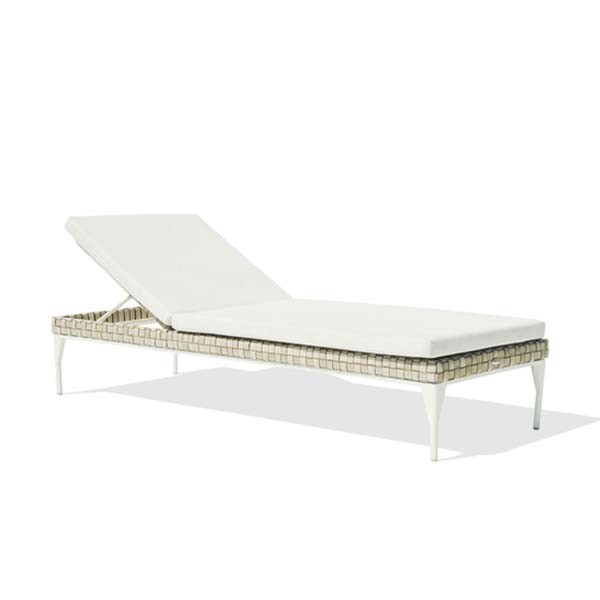 a white chaise lounge with a white cushion