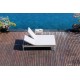 a double lounge chair on a wooden deck next to a pool