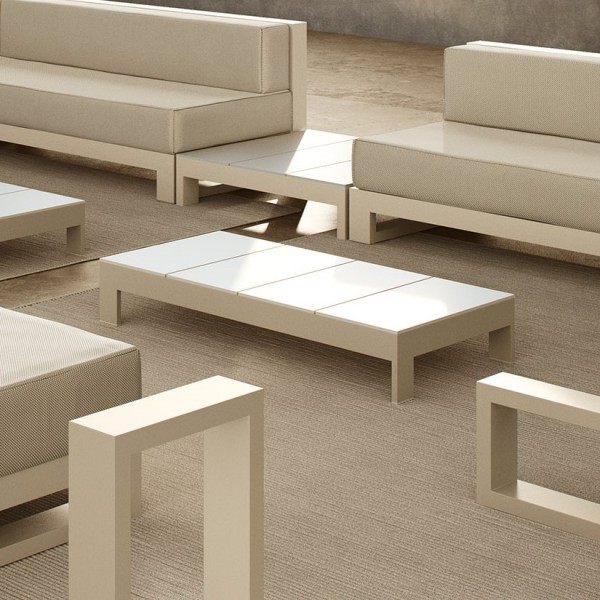outdoor terrace furnished in beige and white tones, with two sofas, two coffee tables, a side table