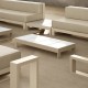 outdoor terrace furnished in beige and white tones, with two sofas, two coffee tables, a side table
