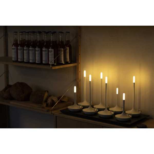 8-piece charging tray with several Wick Pro table lamps lit in a shaded room