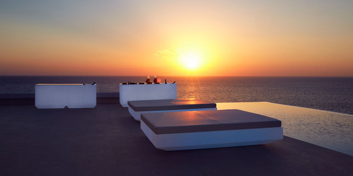 Two Vela Daybeds 200 with White LED Light by Vondom at a Hotel Poolside